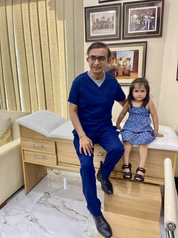 Dr. Farhan Ansari with little girl patient