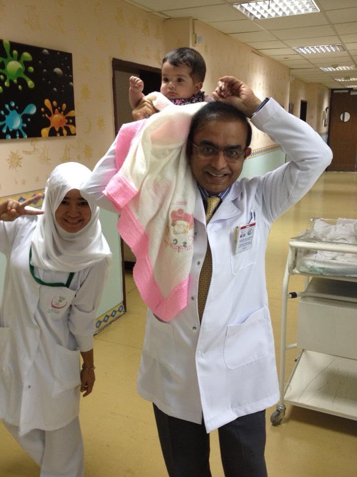 Dr. Ansari playing with a pediatric patient